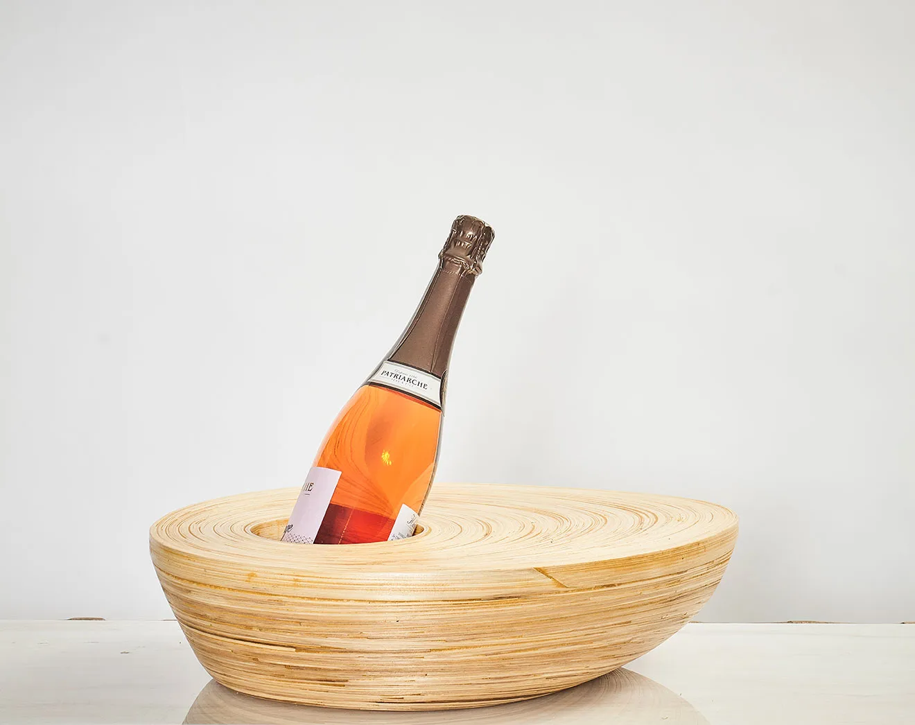 Bamboo accessory used as a stylish bottle holder with a rose champagne bottle.