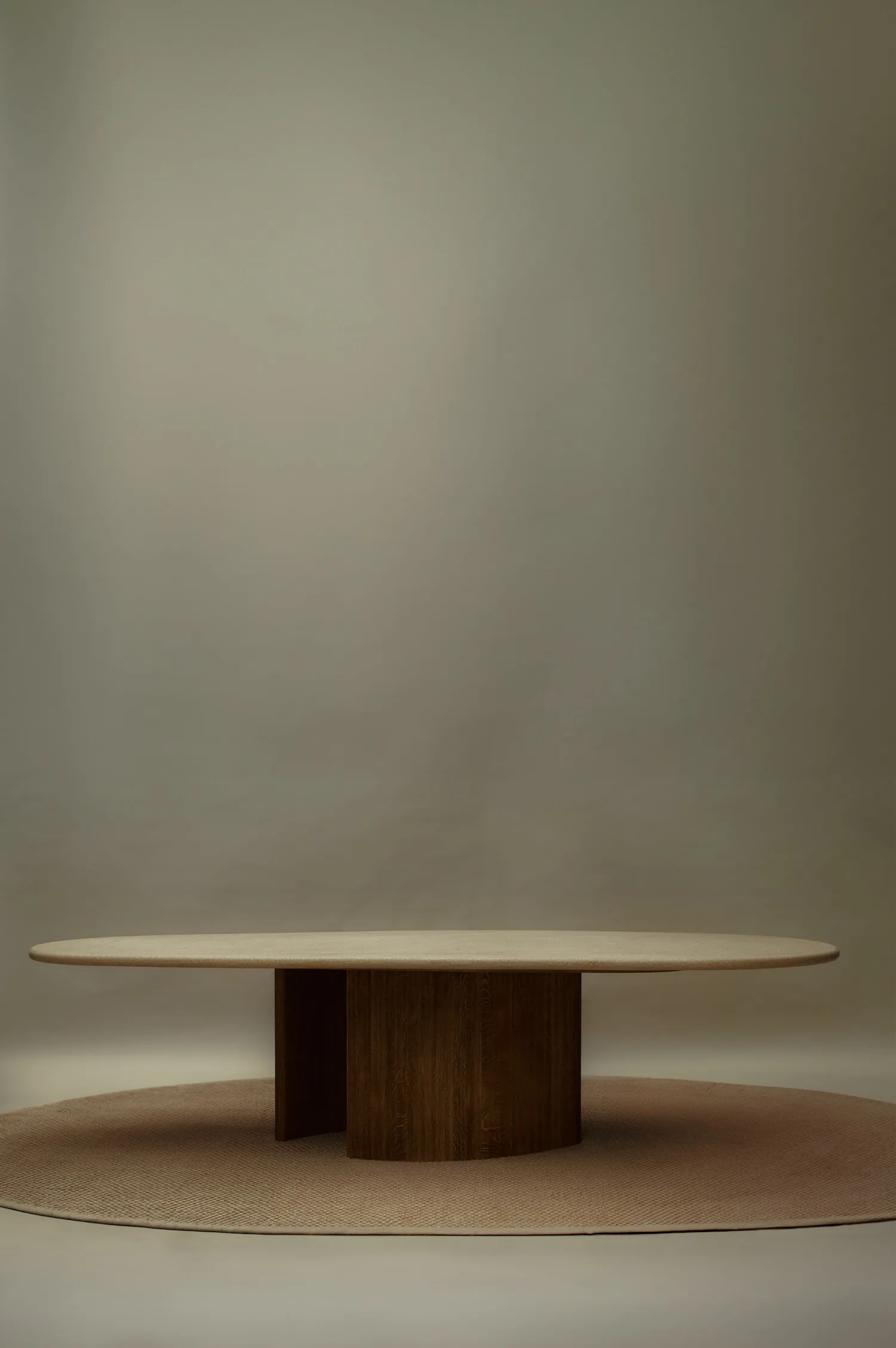 Caprice dining table with a thick top and central cylindrical base.