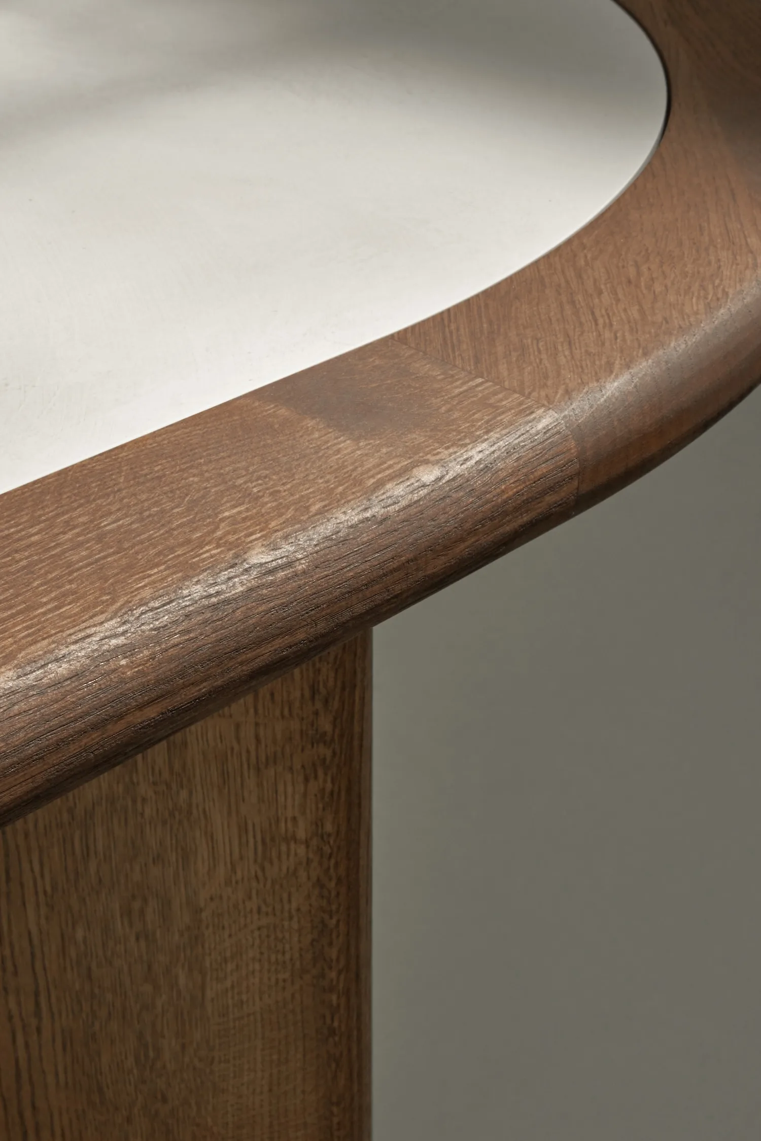 Detail shot of the Hudson table edge, highlighting the contrast between light top and dark oak frame.