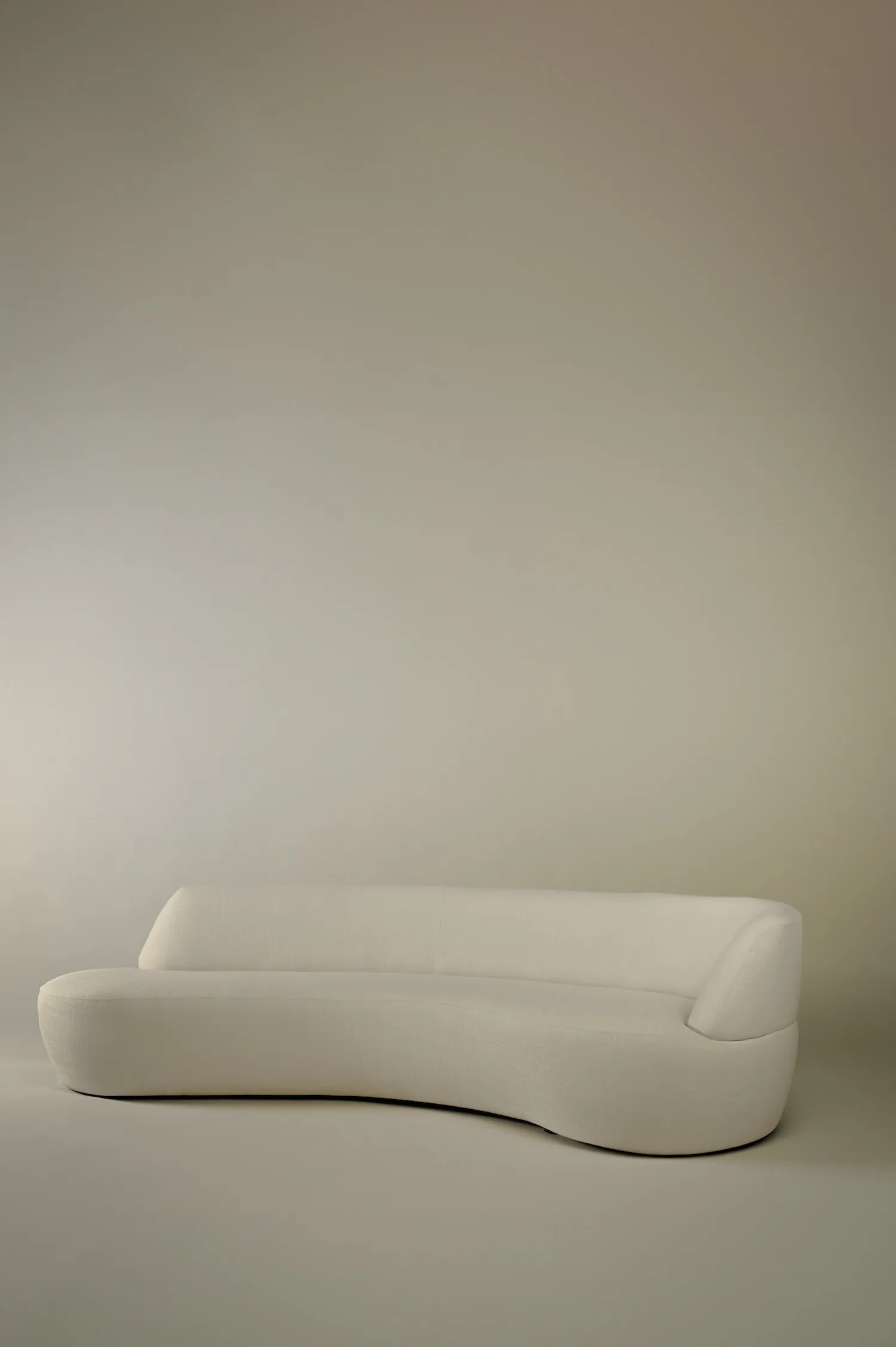 Jane sofa with soft lines and low profile, shown from the side.
