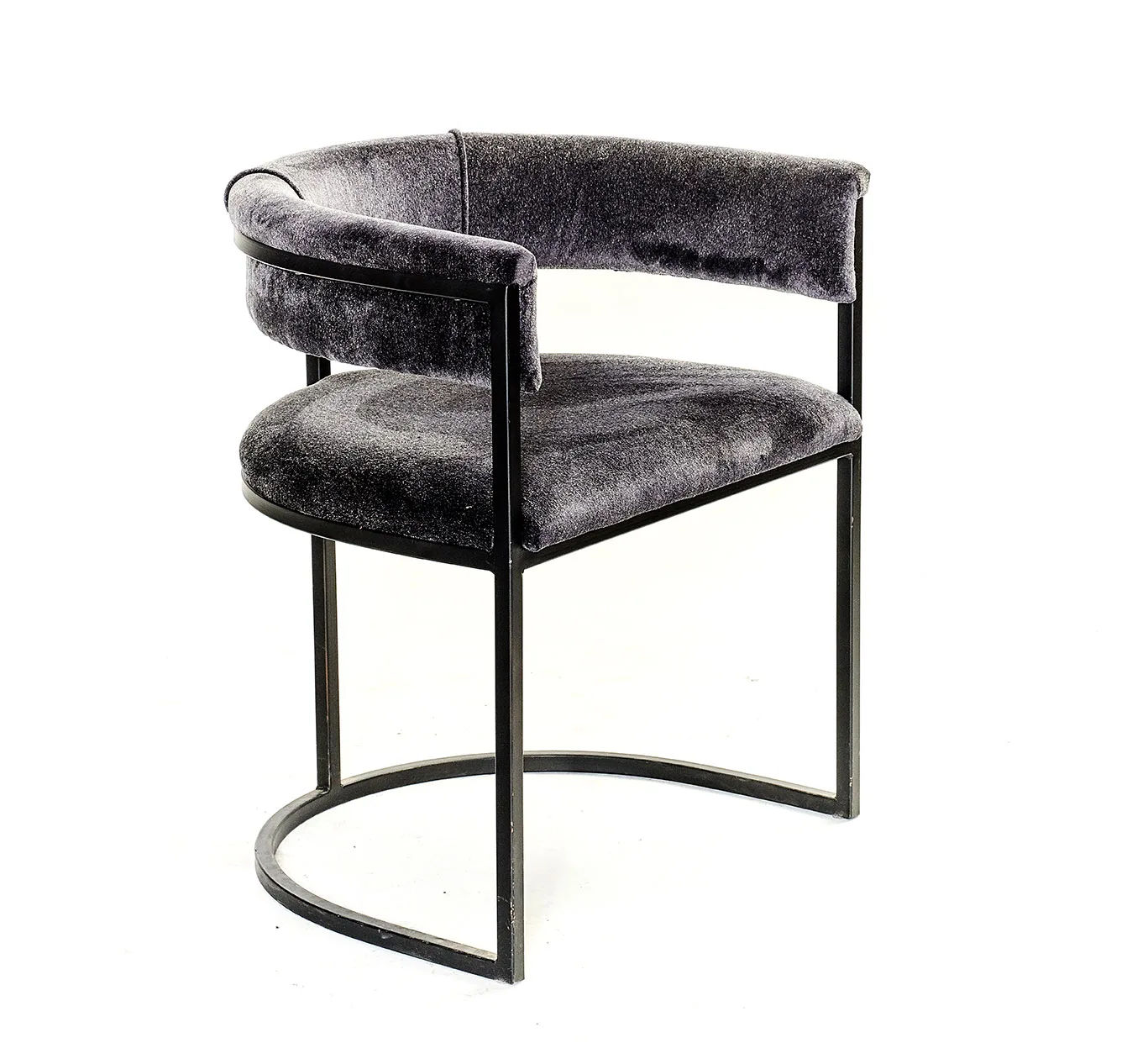 Lucena dining chair in deep grey velvet with black metal frame and curved backrest.