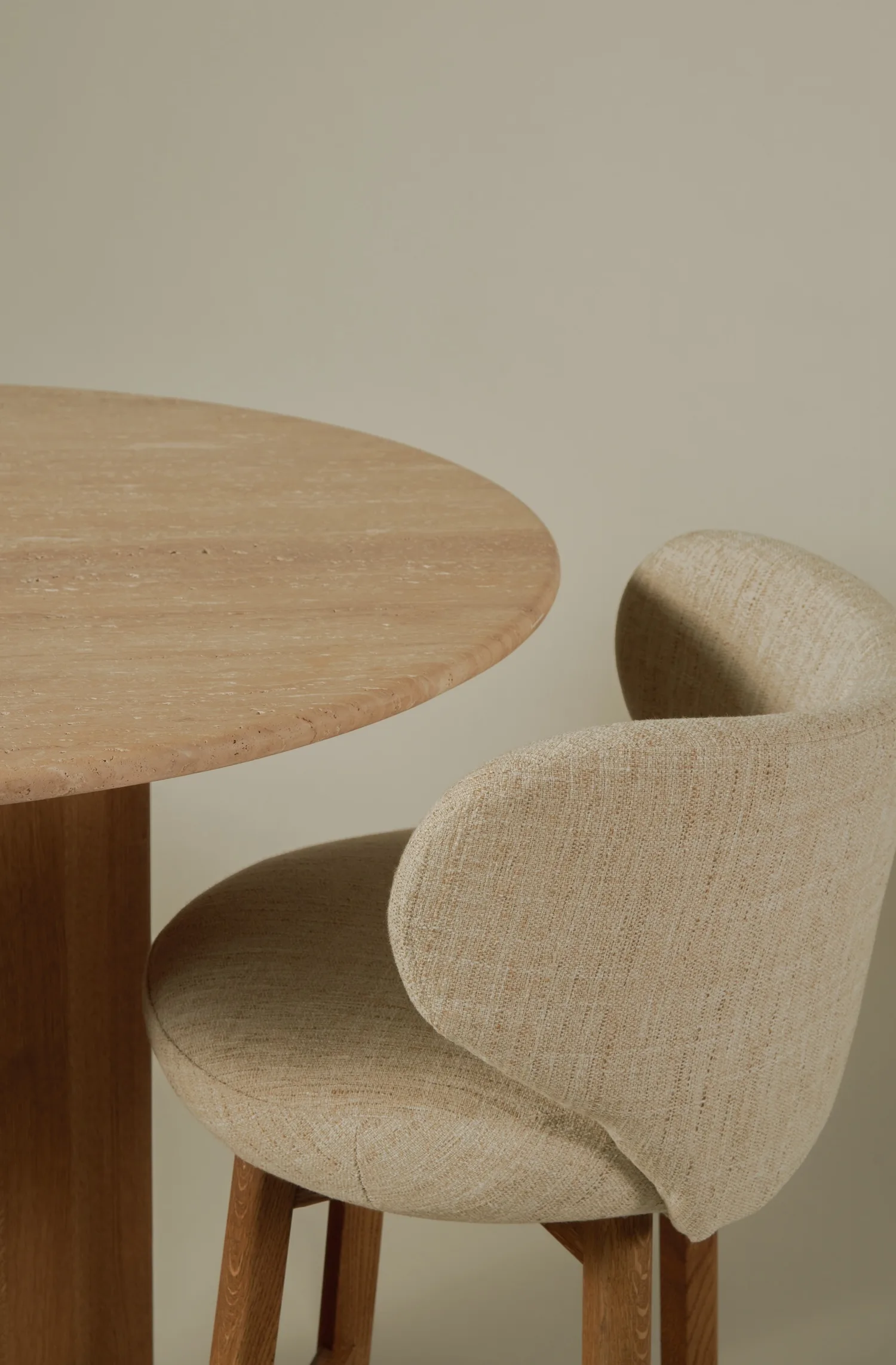 Detailed view of the Margaux barstool’s curved back and round table edge.