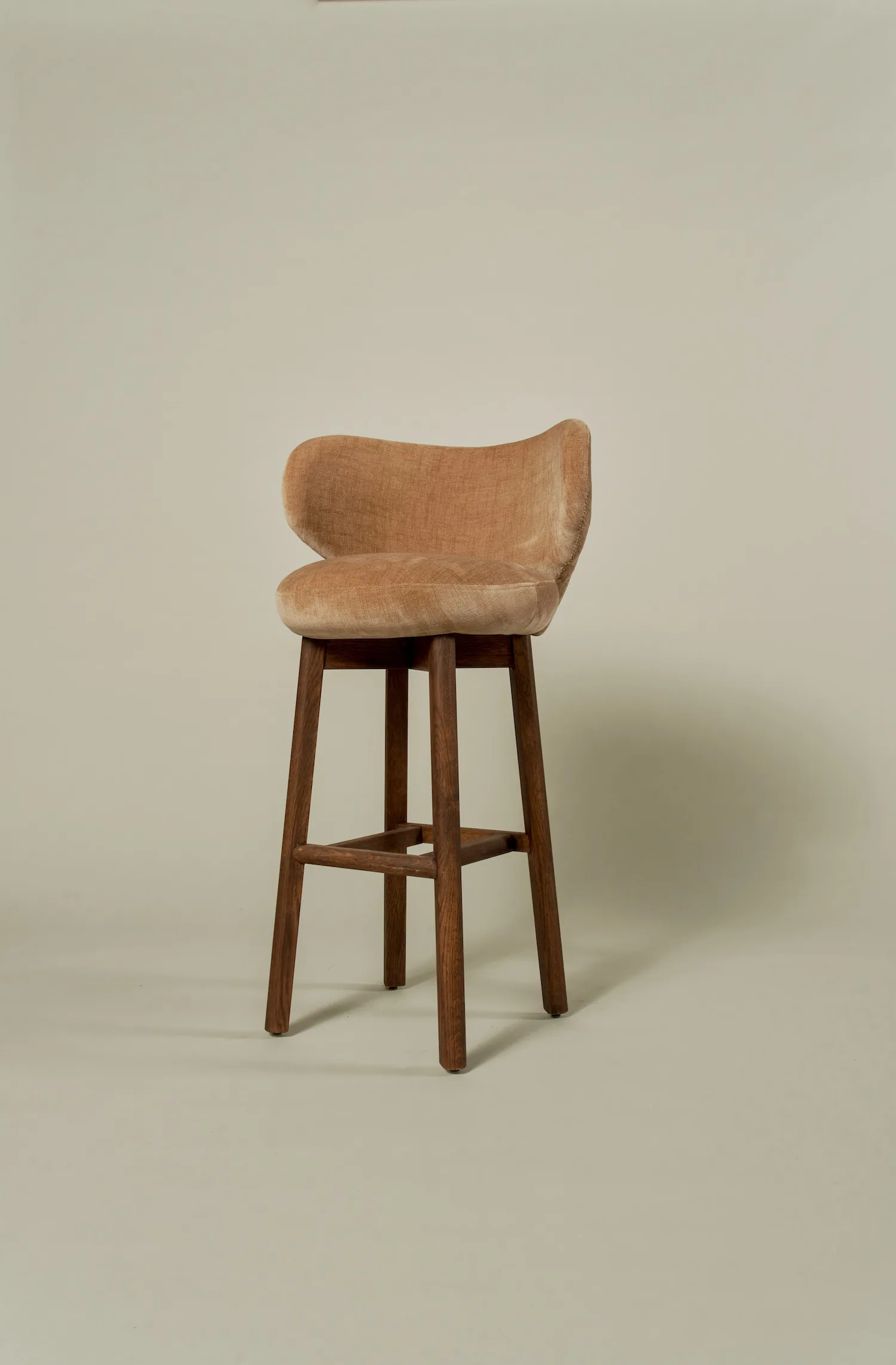 Full view of a terracotta velvet Margaux barstool with walnut-toned legs.
