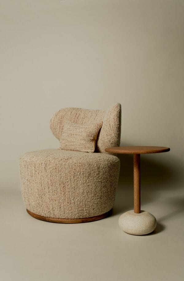 Textured Margaux club chair in boucle fabric, paired with a round wooden side table.