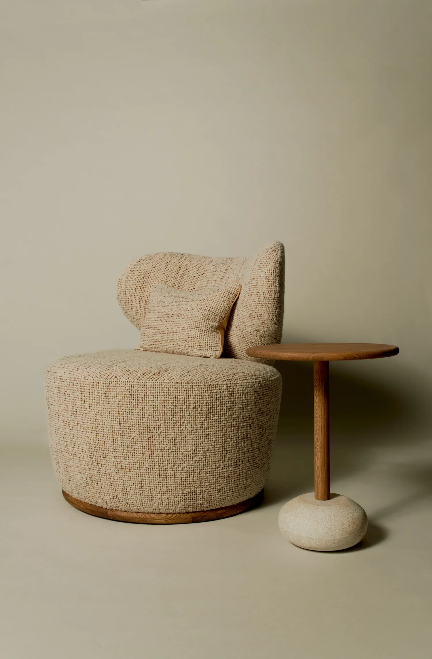 Textured Margaux club chair in boucle fabric, paired with a round wooden side table.
