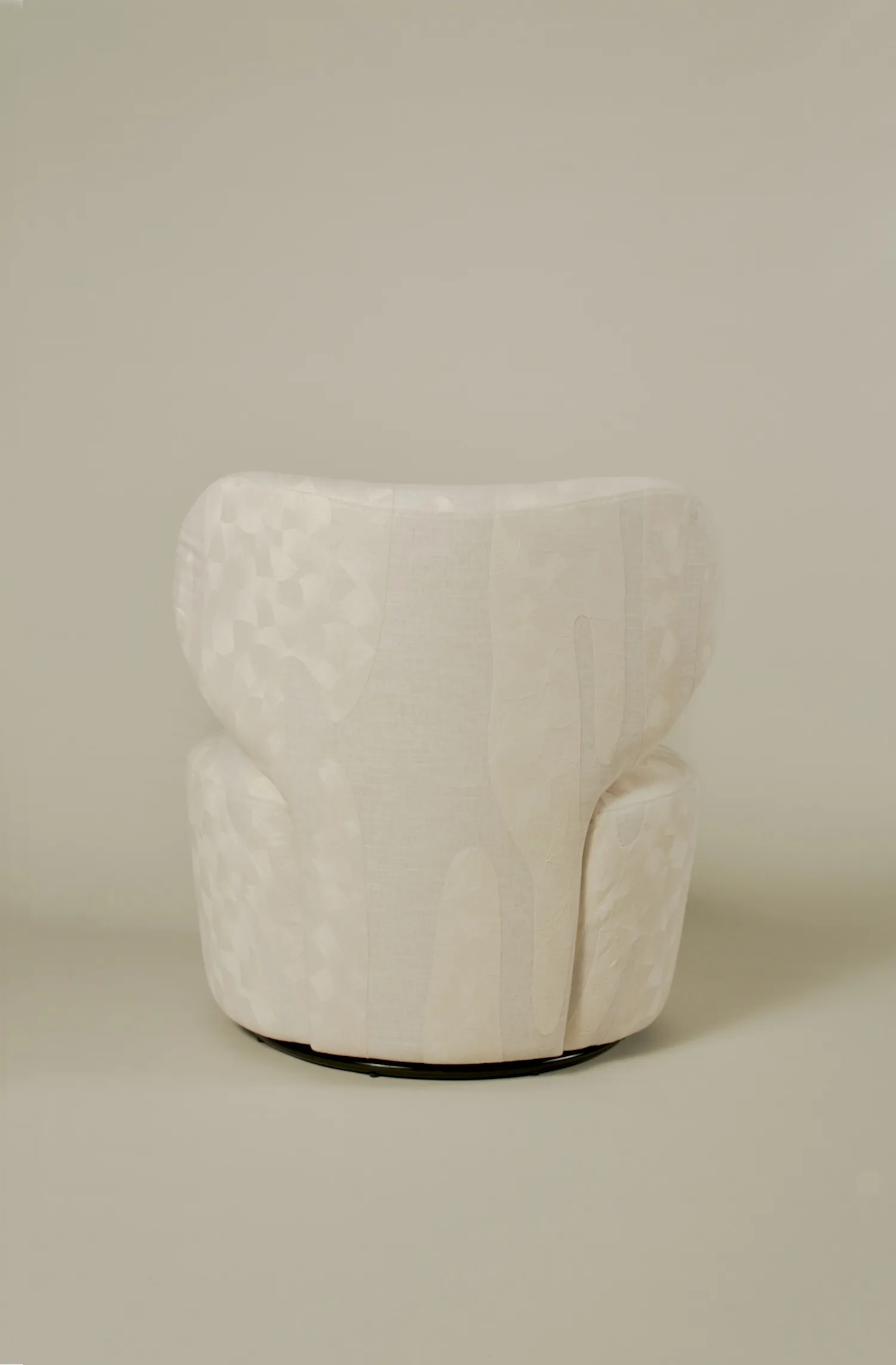 Rear view of the Margaux club chair showcasing its sculptural backrest design.