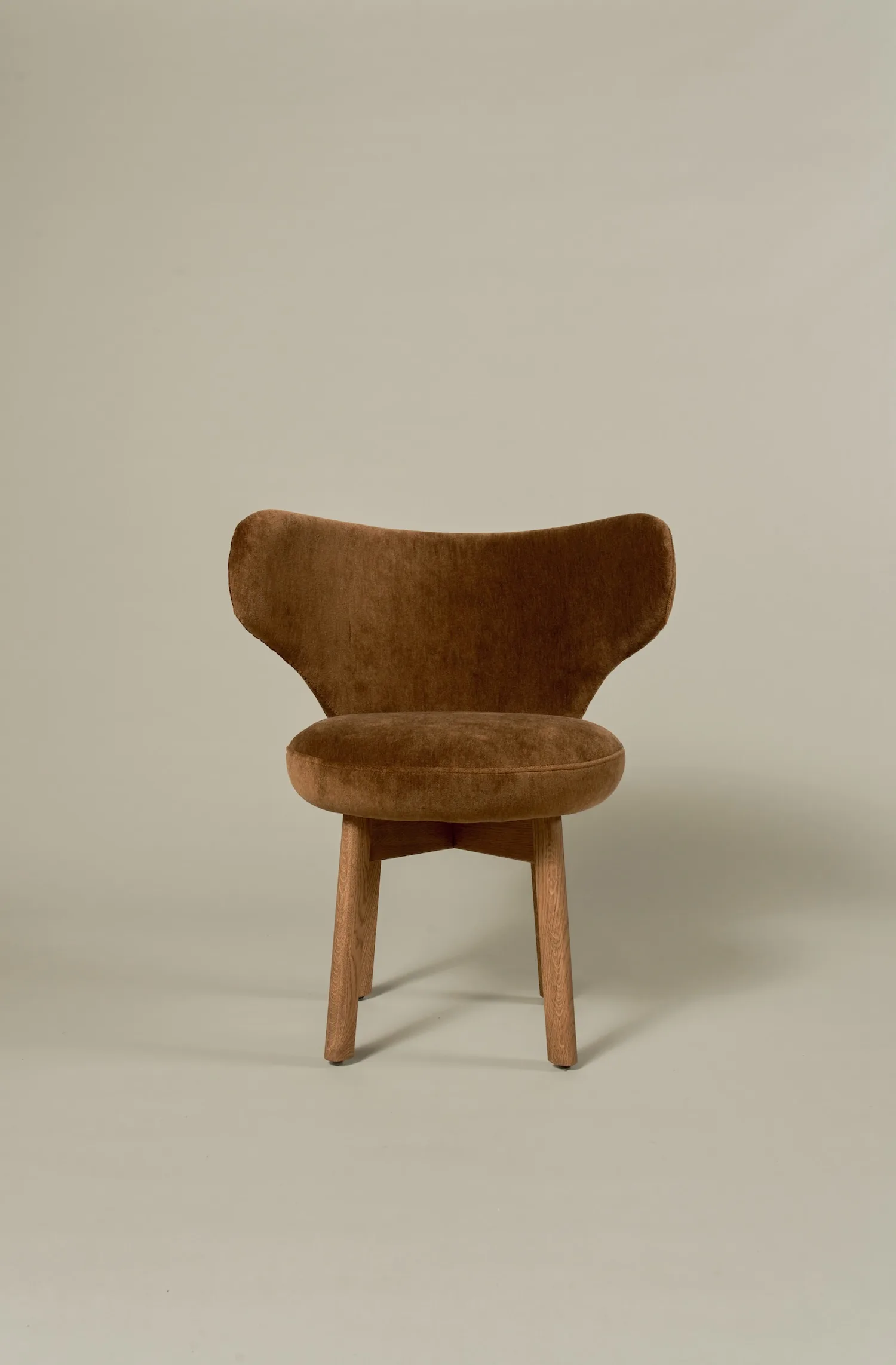 Margaux dining chair in rich brown velvet with sculpted backrest and oak legs.
