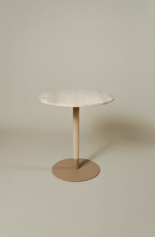 Maxime bistro table with a round travertine top, light wooden stem, and beige metal base.