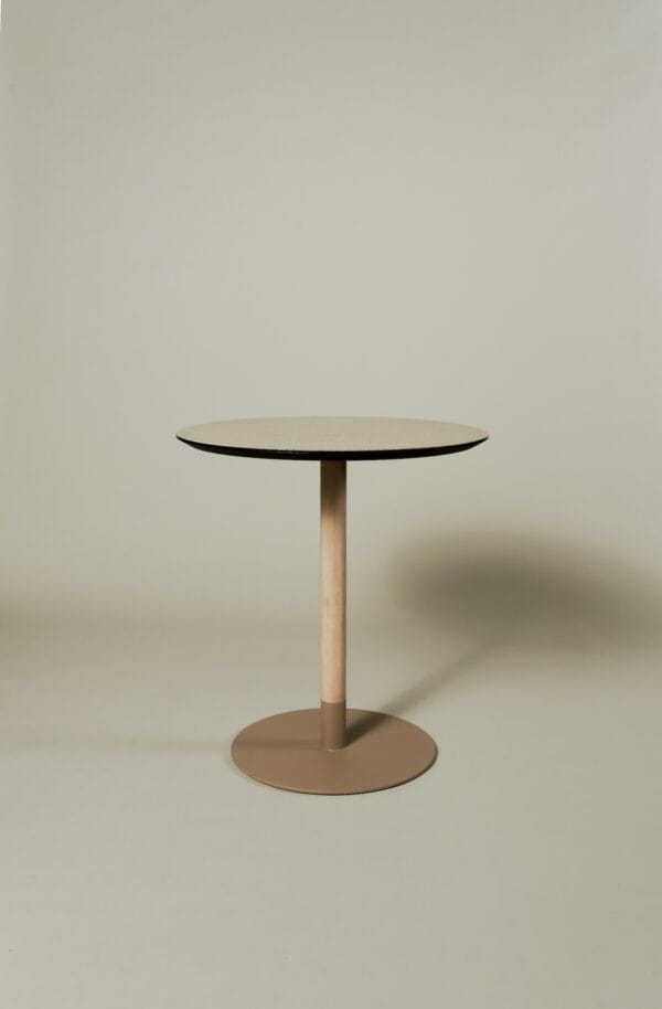 Maxime bistro table with a round beige linoleum top and contrasting black edge on a neutral background.