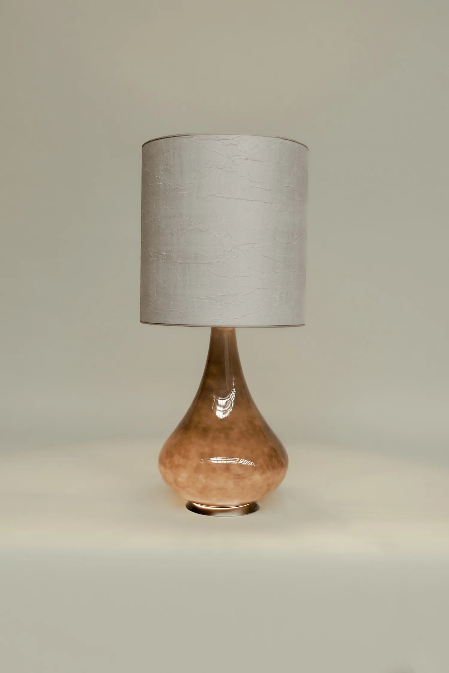 Paula lamp with light cracked-finish shade and a smooth amber-toned glass base.