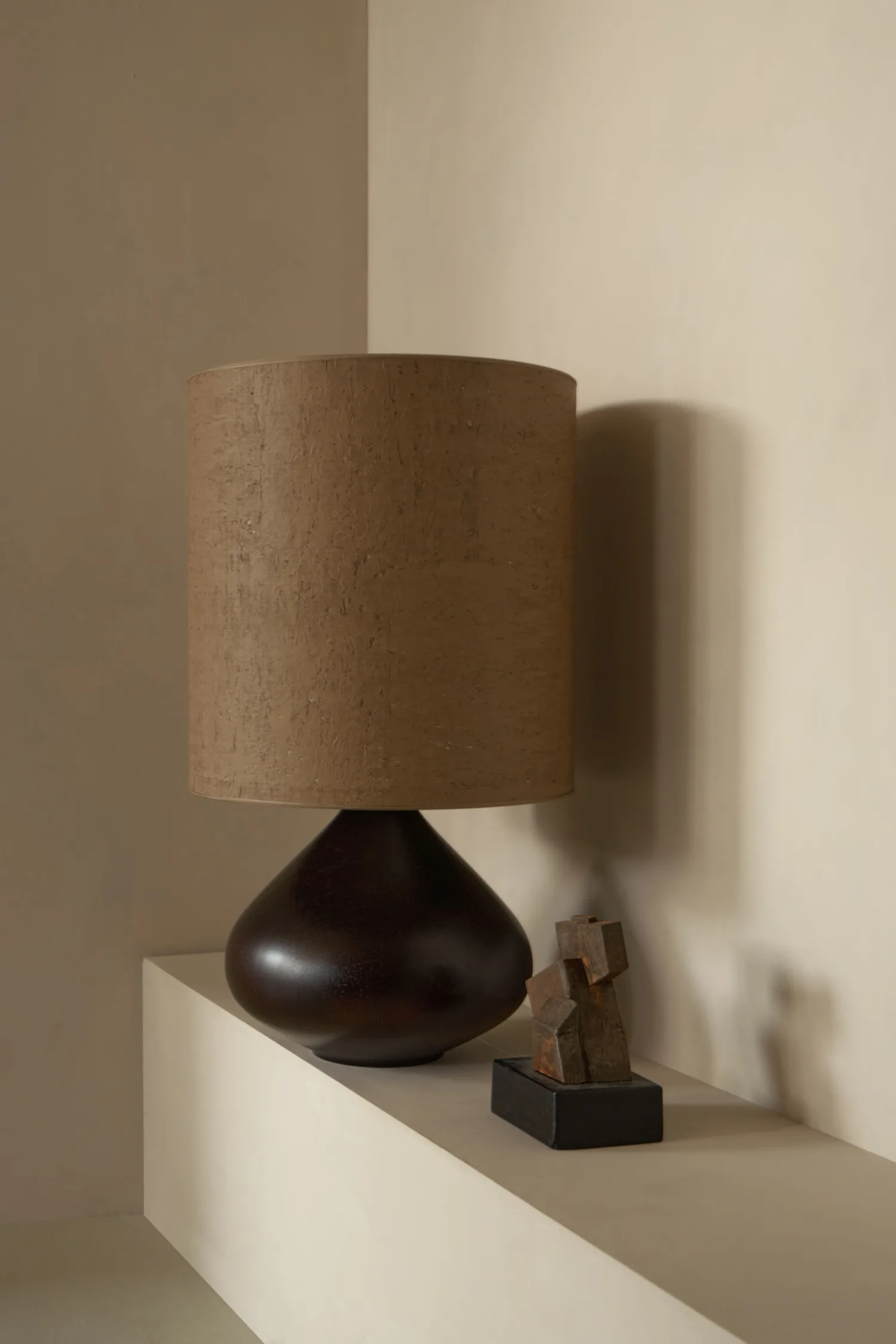 Close-up of dark wood Paula table lamp with matching brown cork-textured shade.