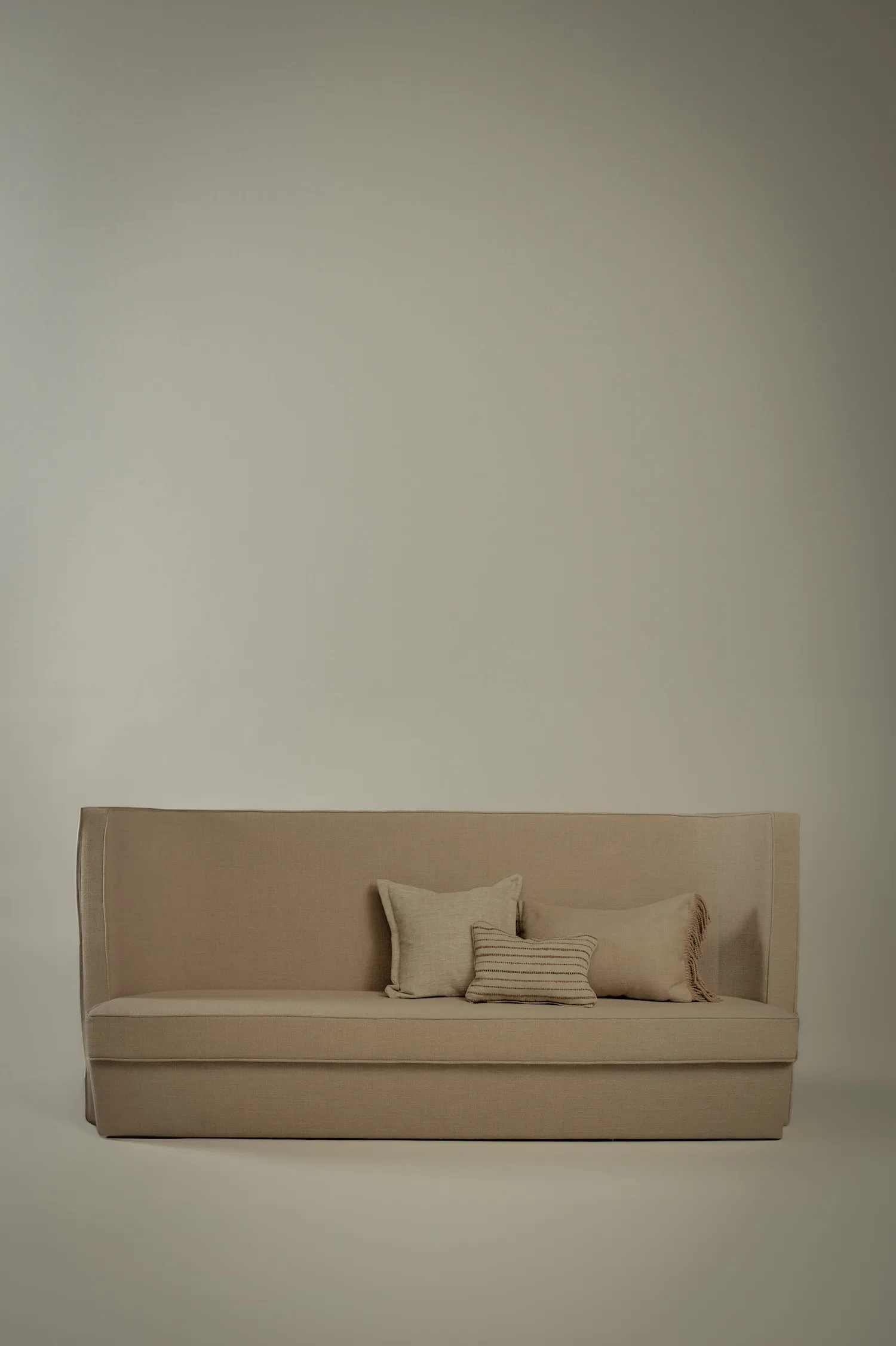 Philippe sofa styled with three textured neutral cushions.