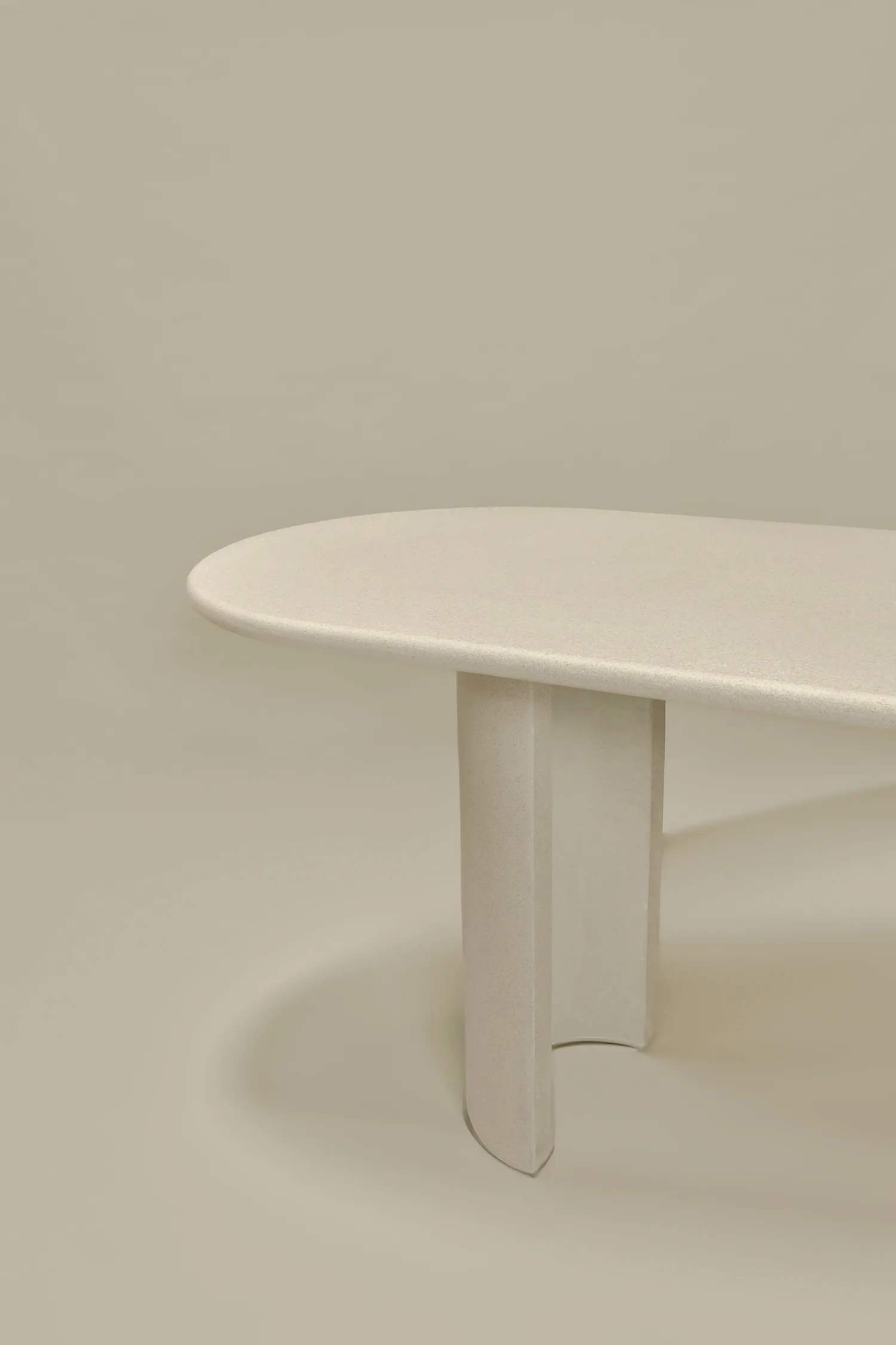 Close-up of the Seine bar dining table showing curved tabletop and sculpted leg detail.