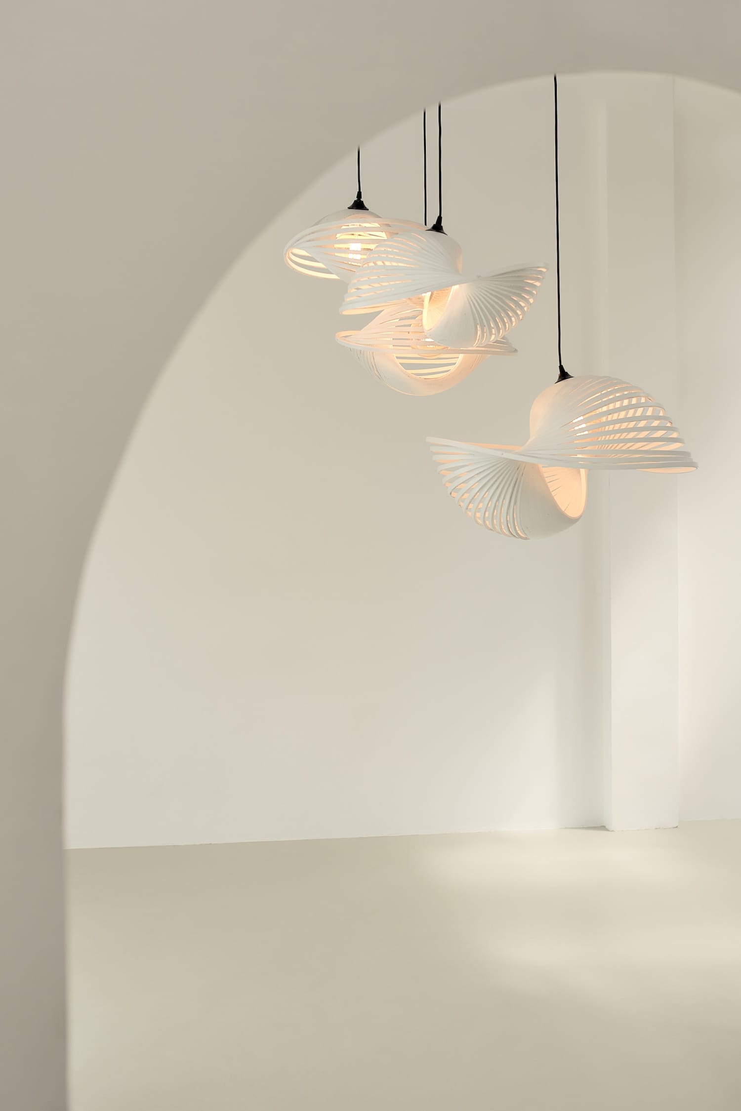Set of three Valbonne Air lights suspended in a minimal interior, radiating soft ambient light.