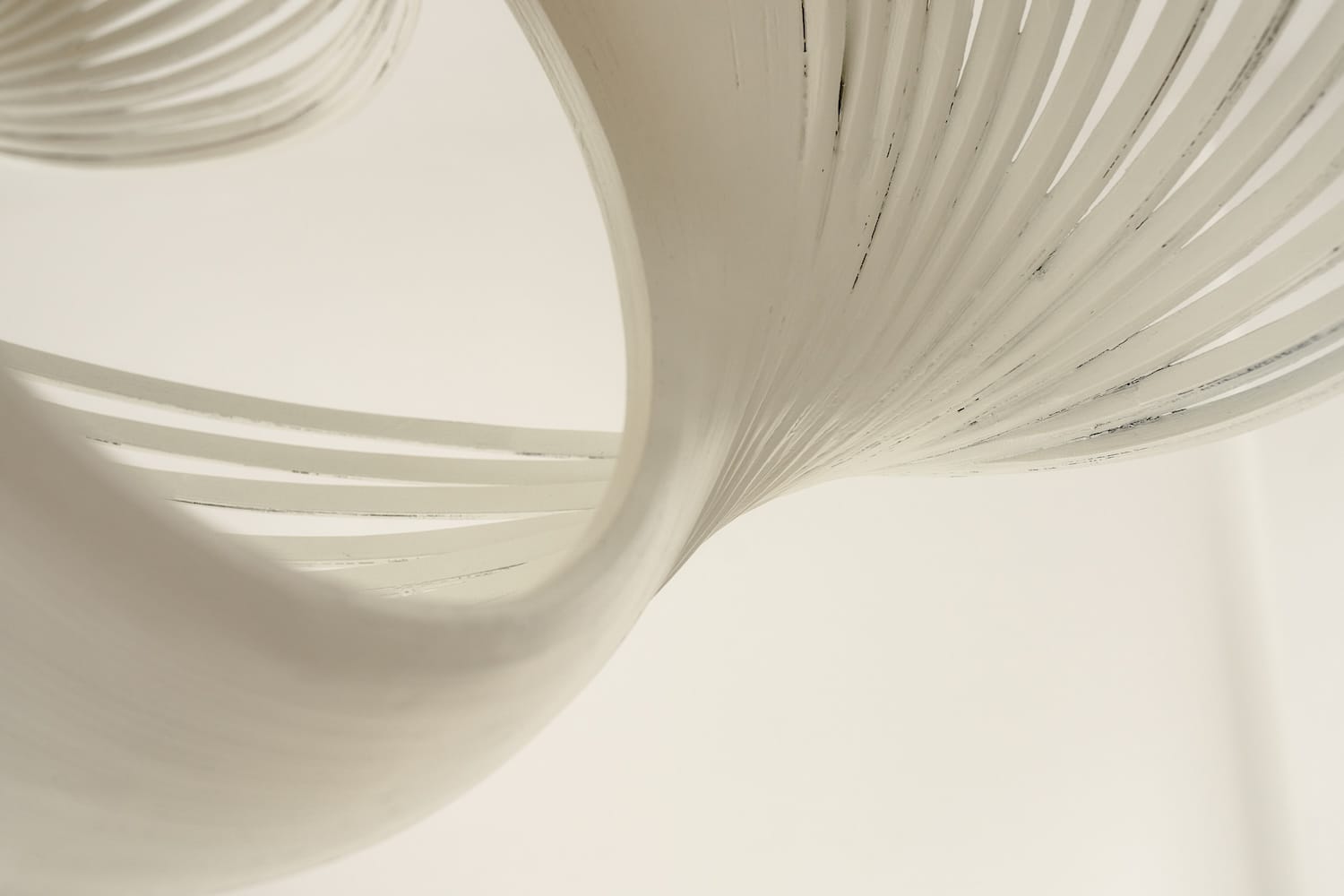 Abstract detail of the Valbonne Air lamp's curved slats and airy design.