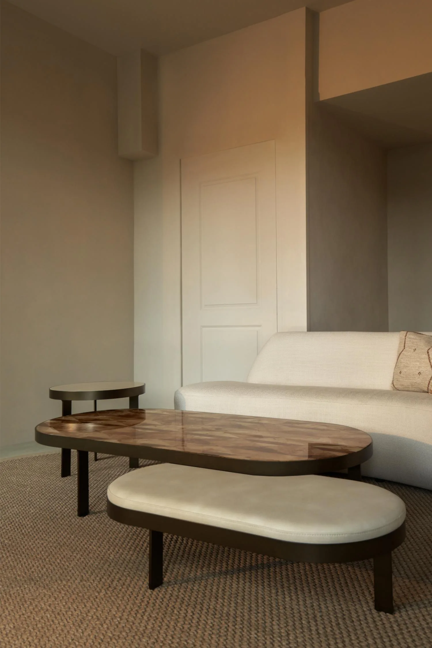 Axel coffee table set with patterned wood top, cream bench, and round side table.