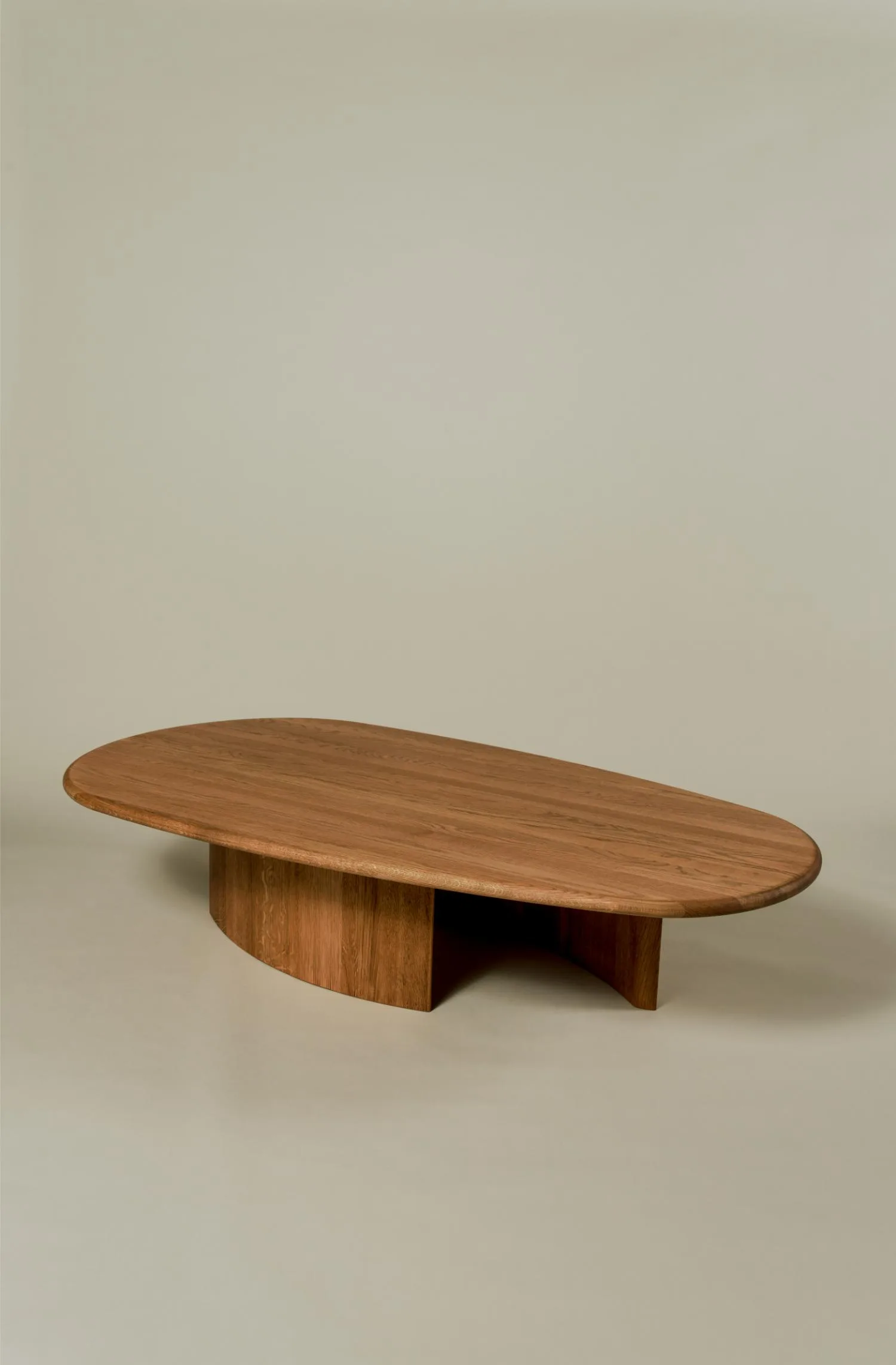 Caprice coffee table with curved edges and a sculptural base.