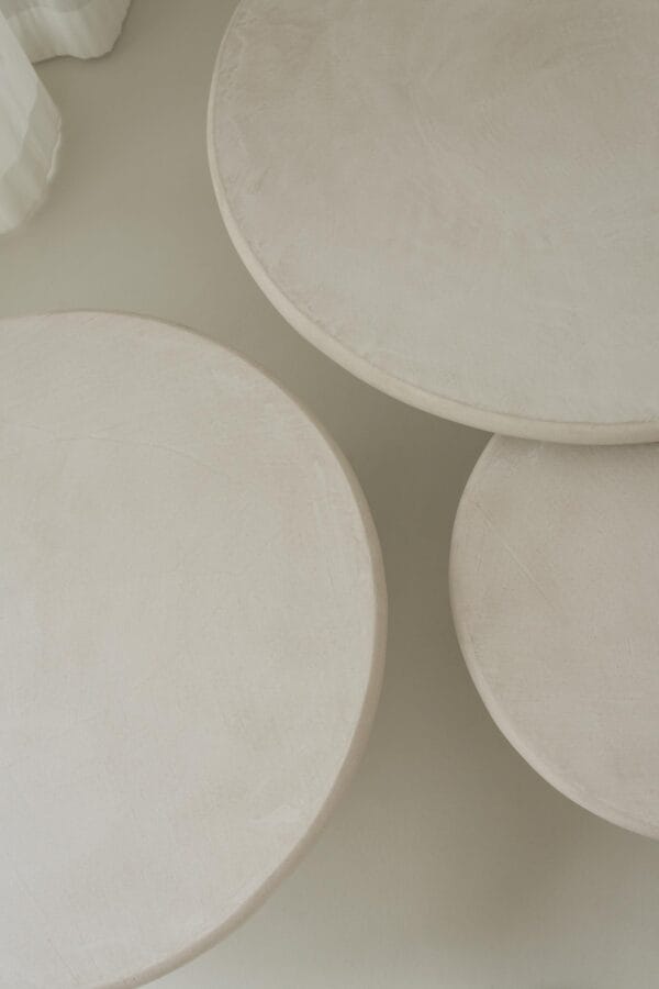 Top view of three round Miller tables in soft-toned plaster finish.
