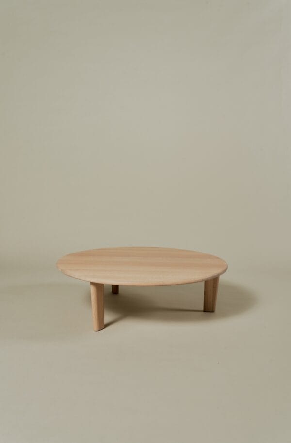 Miller Coffee Table in solid oak with a round wooden top and three legs.